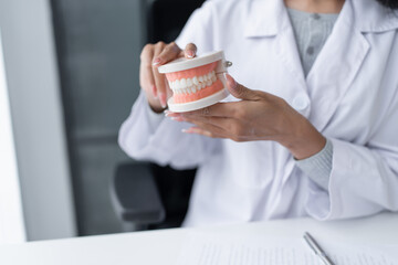 Dentist at dental clinic White healthy tooth with Dental model in oral surgeons discussing jaw x-ray on tablet medicine healthcare oral surgery concept