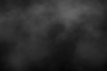 Dark abstract smoky background texture with subtle grey fog and black gradient for mysterious and atmospheric design elements
