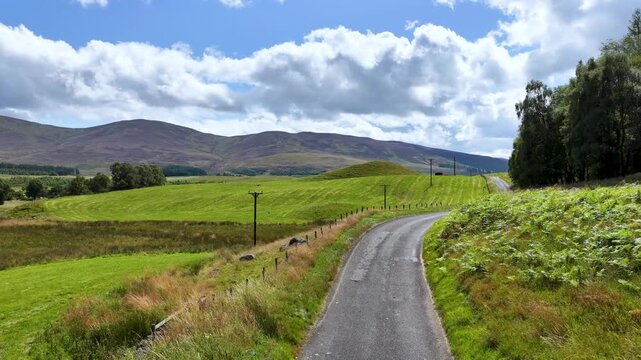 Driving Along a Winding Road in the Scottish Highlands