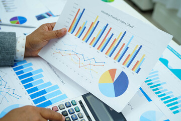 Asian business woman working with financial graph.