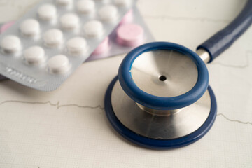 Stethoscope on electrocardiogram ECG with drug, heart wave, heart attack, cardiogram report.