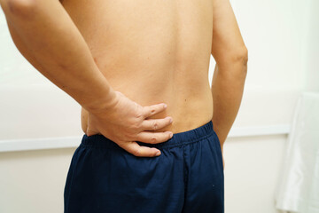 Asian man pain back muscle, spine and bone from accident.