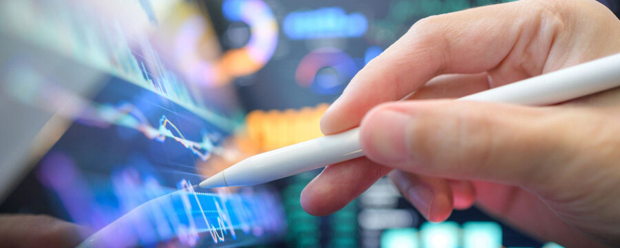 Analyzing financial data on a tablet with a stylus, business and technology concept
