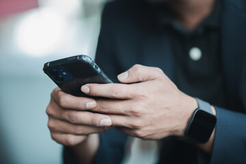 Close-up of business man hands holding smartphone, surfing the internet, checking social media and using mobile applications. Modern communication concept.

