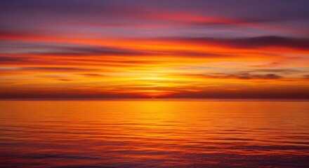 Fototapeta premium Dramatic sunset over calm ocean, reflection on water, orange and purple sky, horizontal format
