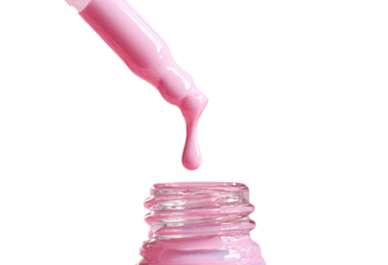 Dropper dispensing pink liquid into bottle