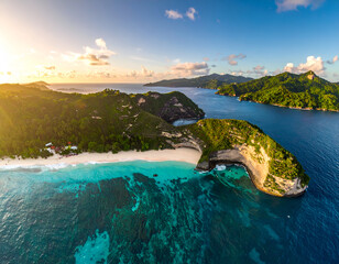  AI-generated image of A breathtaking aerial view of a tropical island featuring lush green vegetation, white sandy beaches, and clear turquoise waters. The coastline includes dramatic cliffs 