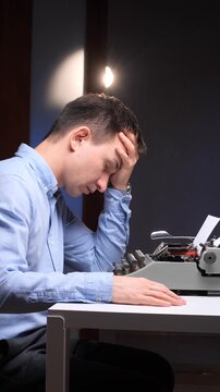 vertical video Writer at a cluttered desk with vintage typewriter, head in hands, exhausted and blocked by creative burnout, struggling under deadline pressure and mental fatigue