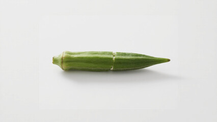 Sliced okra pod, showcasing its vibrant green color and unique star-shaped seed arrangement.