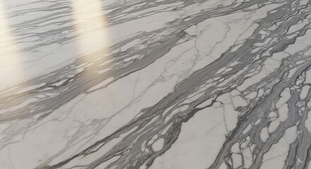 Fototapeta premium Elegant white marble surface with striking grey veining and soft natural light casting subtle shadows, offering a luxurious and sophisticated backdrop for design projects