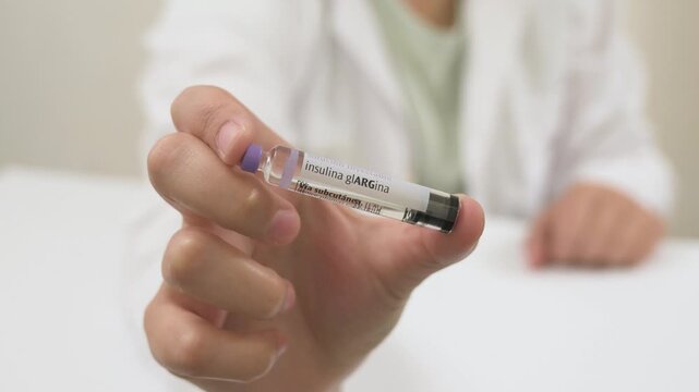 Medical professional showing a cartridge of long acting insulin for subcutaneous injection