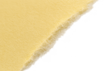 Yellow sheet of paper with a rough, torn edge diagonally across the frame, showcasing texture and transparent background