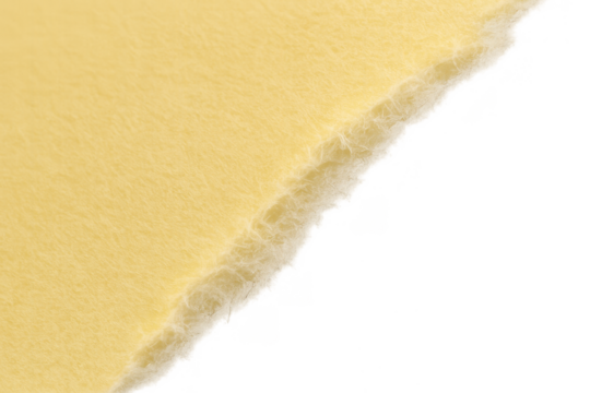 Yellow sheet of paper with a rough, torn edge diagonally across the frame, showcasing texture and transparent background
