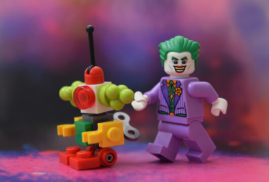 Editorial illustrative image of lego minifigure of Joker in purple suit is walking.