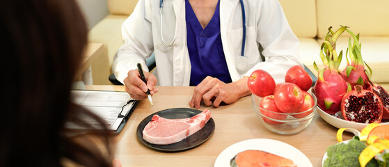 Dietician, male nutrition specialist consulting woman, developing healthy diet, dietary program. Dietary consultant asking, giving male patient advice, help, nutritional information, new meal plan