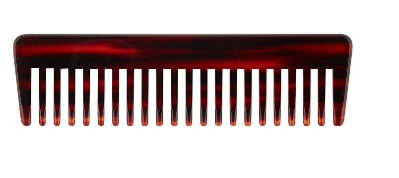 Comb with a pattern resembling a turtle shell cut out isolated transparent background