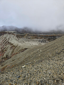 Unique landscape of the crater of Nakadake in Mount Aso Japan with rock and mountain background