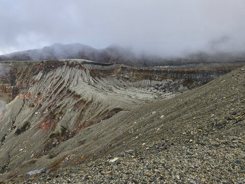 Unique landscape of the crater of Nakadake in Mount Aso Japan with rock and mountain background
