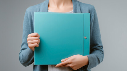 A woman is holding a blue folder