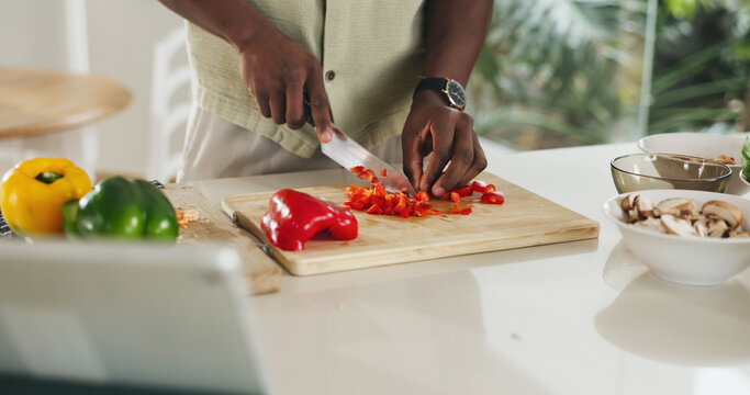 Hands, tablet or person cooking with vegetables in home for healthy lunch, online recipe or meal prep. Tech, man and cut ingredients in kitchen for dinner tutorial, website steps and culinary skills - Powered by Adobe