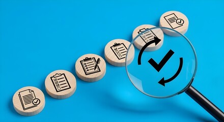 Magnifying glass examining a series of wooden discs with checklist icons, symbolizing verification, approval, and quality control in a process