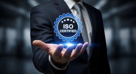 Businessman holding a glowing blue iso certified badge in his hand, representing quality and standards
