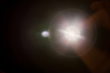Bright White Lens Flare with Circular Halo on Dark Background, Abstract Artistic Light Burst, Modern Visual Effect, Dynamic and Inspiring Backdrop for Creative Design and Presentations

