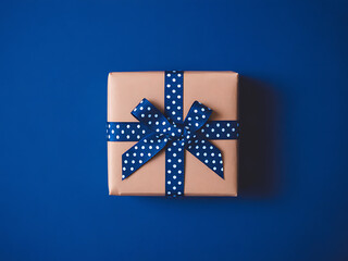 Simple brown gift box tied with blue polka dot ribbon decoration
