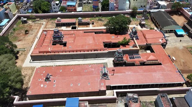 Aerial view of the inner complex of Tenkasi Kasi Viswanathar Temple, Tamil Nadu, showcasing intricate gopurams and red-tiled roofs in a traditional Dravidian architectural style.