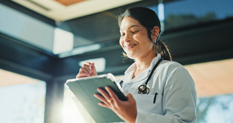 Smile, doctor and woman with tablet for medical info, patient history or telehealth in clinic. Tech, healthcare professional and person in hospital with insurance records, wellness email or research