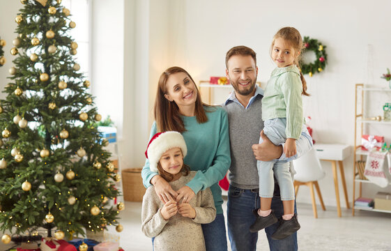 Portrait of a happy family with children celebrating New Year or Christmas at home, sharing holiday joy. Festive season brings warmth, bonding, and holiday cheer, creating joyful memories together.