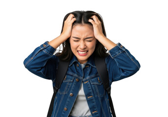 Young woman student with backpack, distressed and frustrated, holding her head in hands