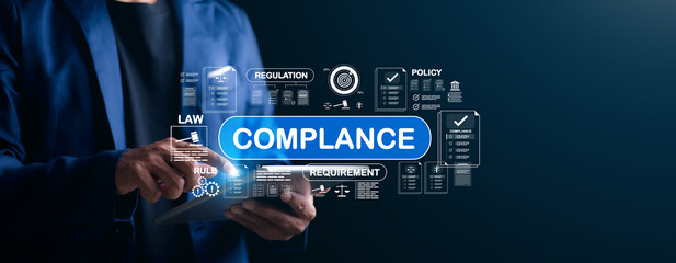 Businessman using digital tablet with virtual interface showing compliance, law, regulation, policy, and requirement. Concept of corporate governance and legal standards.