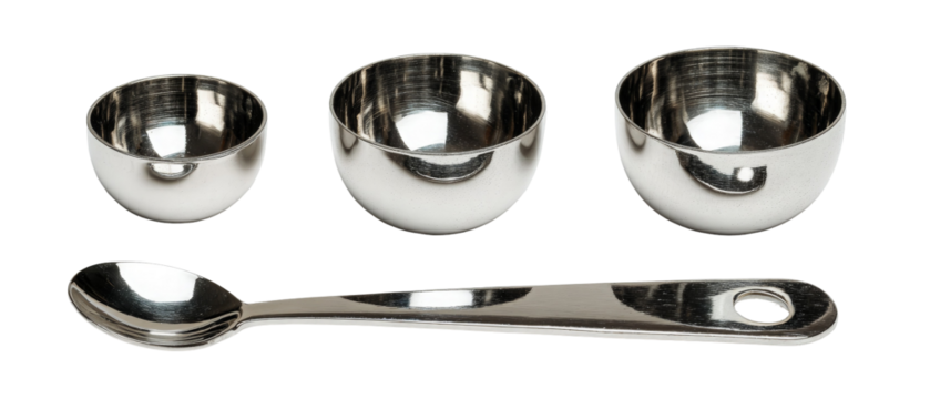 A set of three shiny stainless steel measuring cups alongside a stainless steel spoon, arranged neatly on a white background, ideal for culinary use and kitchen organization