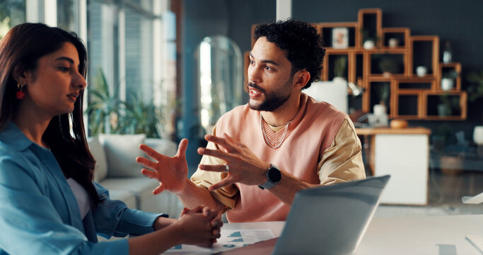 Talking, man and woman with laptop, office and planning for design project, discussion and paperwork. Graphic designer, brainstorming and colleagues with tech for brand identity, graphs and documents - Powered by Adobe