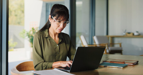 Business, woman and typing with laptop at house for real estate, property report and research....