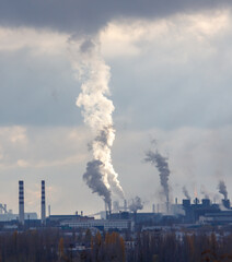A large cloud of smoke is rising from a factory