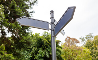 A street sign with a black arrow pointing to the left
