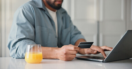 Man, hands or credit card in home with laptop, payment or Black Friday discount for online...
