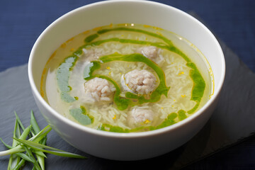Hearty chicken meatball soup with green garnish