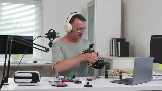 Senior content creator assembling robot car during live stream