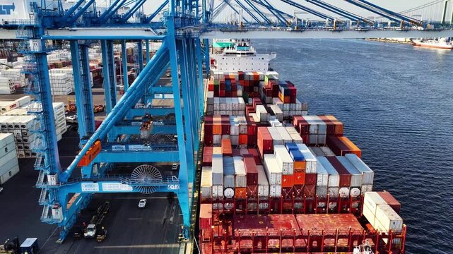 Aerial Timelapse of Cargo Ship Being Loaded and Unloaded in Port