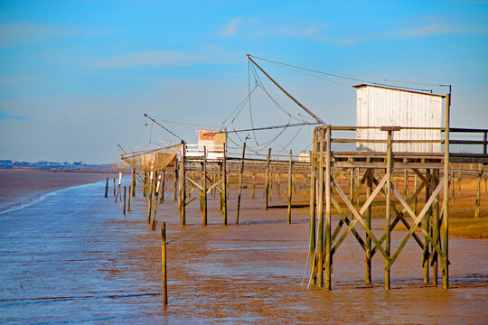 raditional Carrelets Fishing Huts on the Gironde Estuary at Low Tide under Blue Sky, France