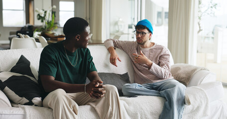 Men, friends or discussion on sofa with gossip for life update, bonding together or weekend hangout. People, chill or relax with conversation for advice, wellness or storytelling in home living room.