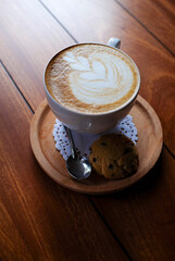 cup of cappuccino on wooden table