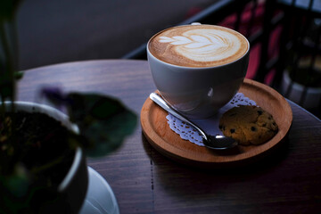 cup of cappuccino on wooden table