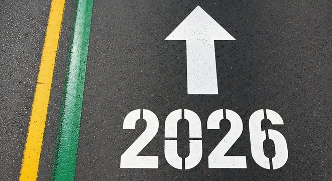 Forward movement into the year 2026 marked on asphalt pavement with a clear white arrow indicating direction and colorful parallel lines.