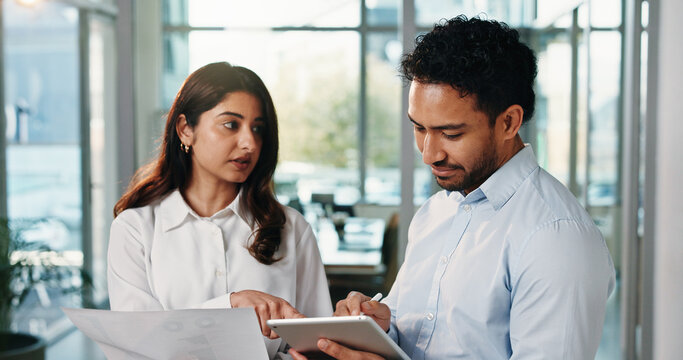 Business people, documents and discussion with tablet in office for corporate proposal or research. Businessman, woman or colleagues with paper or technology for analytics or performance review