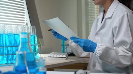 Female scientist analyzing data and working in a modern laboratory - Powered by Adobe