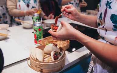 Shev puts filling into bao buns